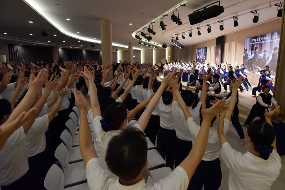 坐在观众席的法海演绎志工，与台上静思菩提钟鼓队演绎志工相呼应，举手投足间传递佛法。摄 / 林孟才