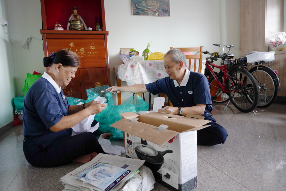 Ms Ng and her husband, Mr Lee Kong Wai in the midst of sorting recyclables at home. (Photo by Chan May Ching)